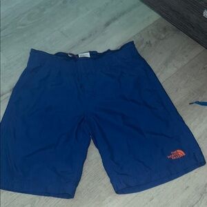 The North Face Royal blue  and orange logo swim trunks s/p size 7/8